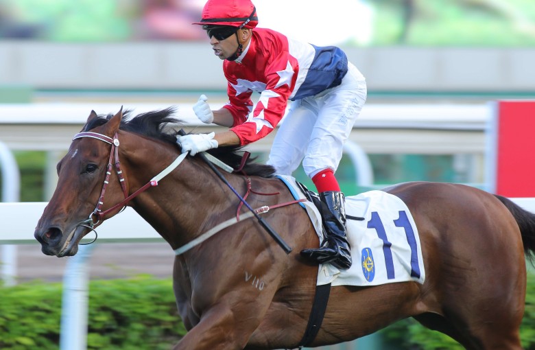 Joao Moreira gives a fist-pump as Joyful Trinity runs over the top of his rivals in the Group Three Celebration Cup. Photos: Kenneth Chan