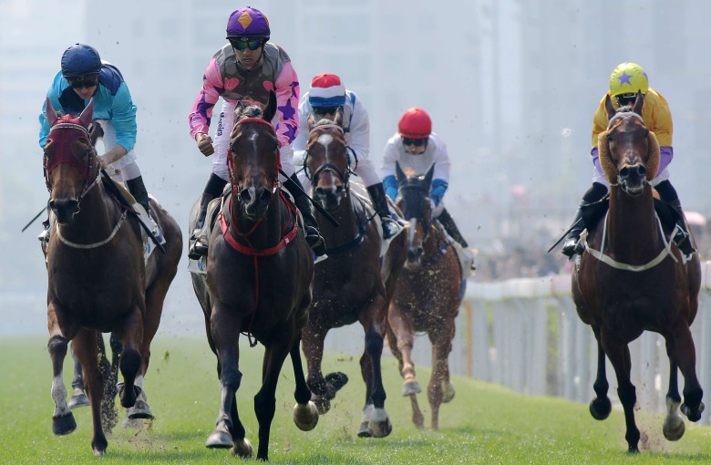 Joao Moreira guides Amazing Kids (pink and purple) to victory in the Group Three Bauhinia Sprint Trophy. Photos: Kenneth Chan