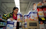 Chinese daigou shopping agent Na Wang selects an Australian breakfast cereal product during a shopping trip for Chinese customers at an Australian supermarket in Sydney. Photo: Reuters