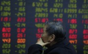 An investor monitors stock prices at a brokerage house in Beijing on October 24. Photo: AP