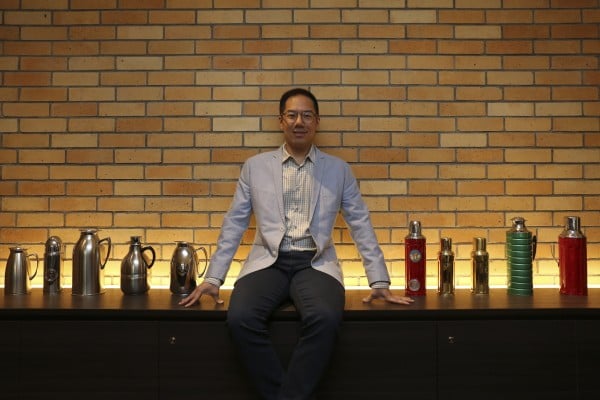Raymond Leung with a display of Camel vacuum flasks at the Camlux Hotel, opened in the former flask factory. Photo: Jonathan Wong