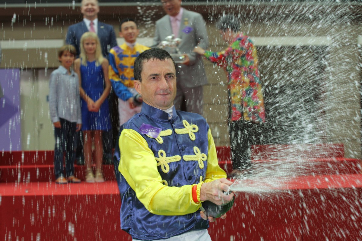 Douglas Whyte gives his many fans a champagne moment after being crowned champion jockey for a 13th straight season - and then gave arch-rival Zac Purton a spray too. Photo: Kenneth Chan