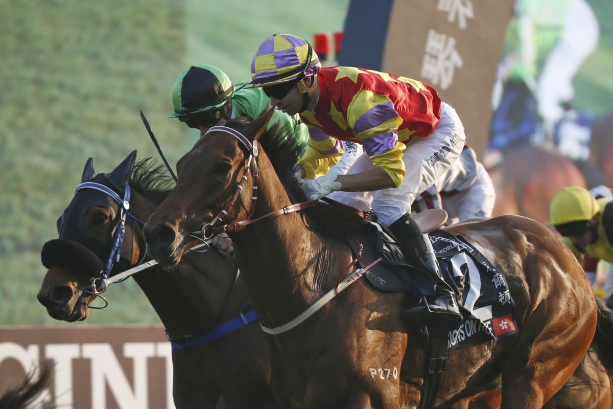 Designs On Rome (Joao Moreira) edges out Military Attack (Zac Purton) to win the HK$25 million Longines Hong Kong Cup at Sha Tin. Photo: AP
                         