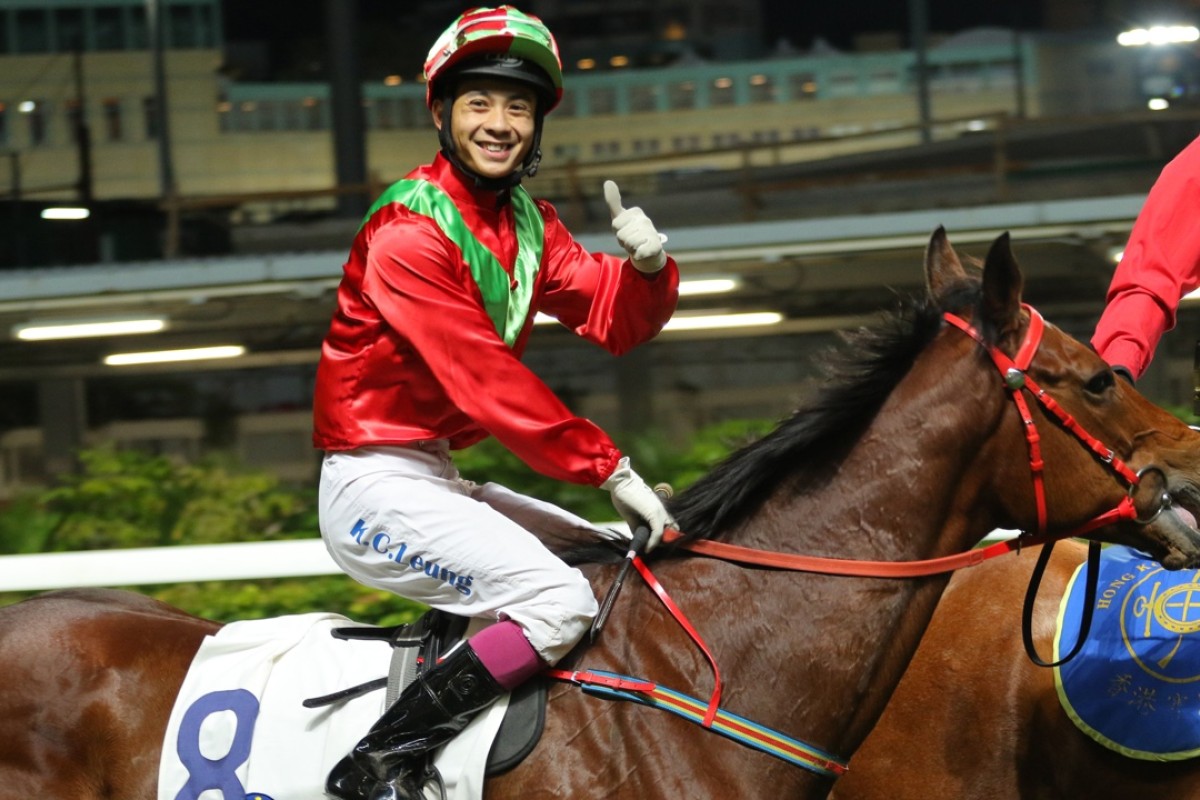 Derek Leung gives a thumbs-up to the crowds as he returns after winning the January Cup on Flame Hero last night. Photo: Kenneth Chan