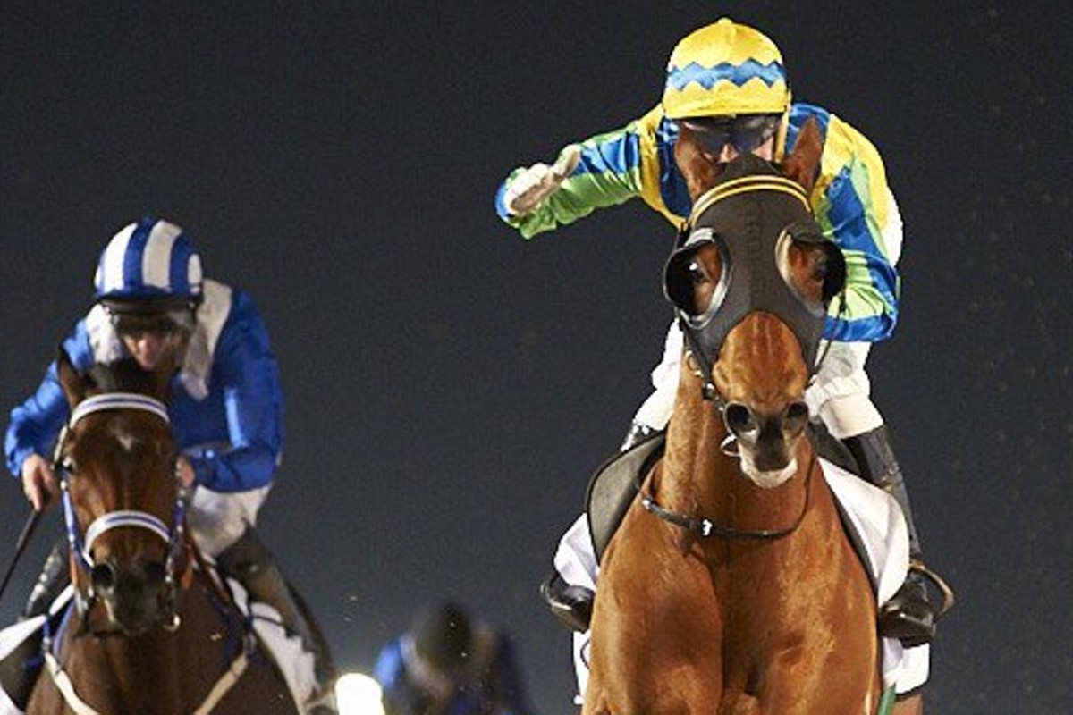 Gerald Mosse salutes as Rich Tapestry wins the Al Shindagha Sprint from Muarrab (Paul Hanagan). Photo: Dubai Racing Club
