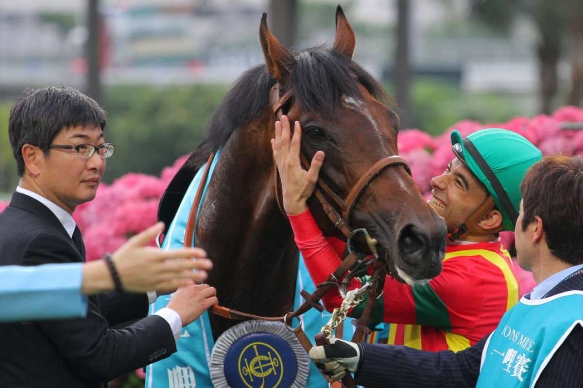 Joao Moreira gives Maurice a hug as trainer Noriyuki Hori looks on after the team combined to win the Champions Mile. Photo: Kenneth Chan