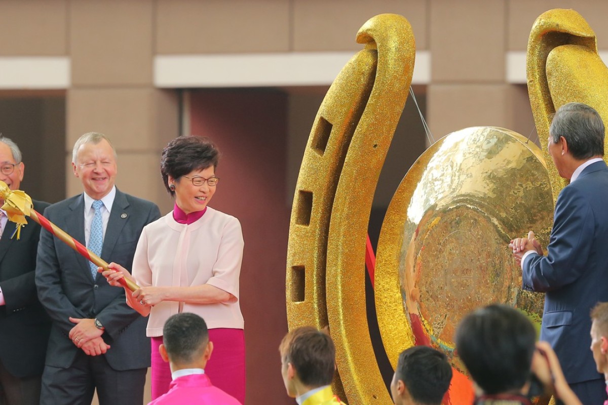 Chief Executive Carrie Lam Cheng Yuet-ngor opens the racing season by striking a gong at Sha Tin. Photos: Kenneth Chan