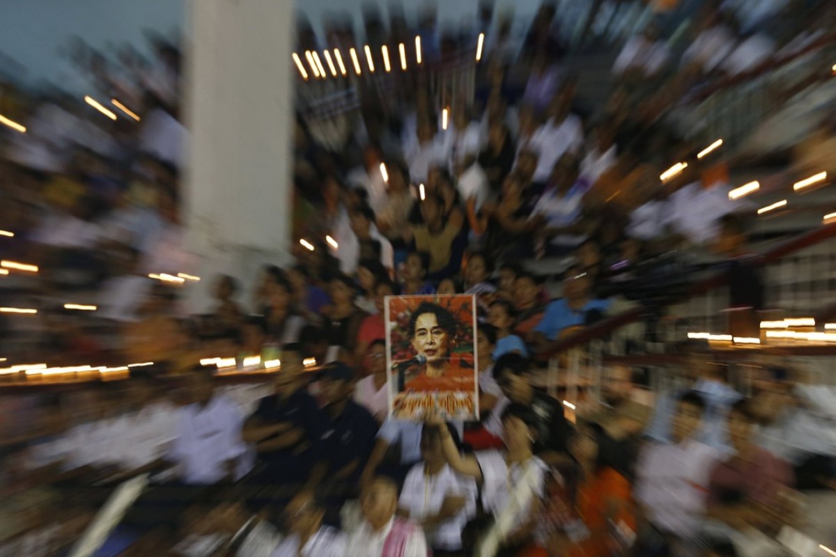 People hold a portrait of Myanmar state counsellor Aung San Suu Kyi at a prayer gathering in Yangon. Photo: EPA