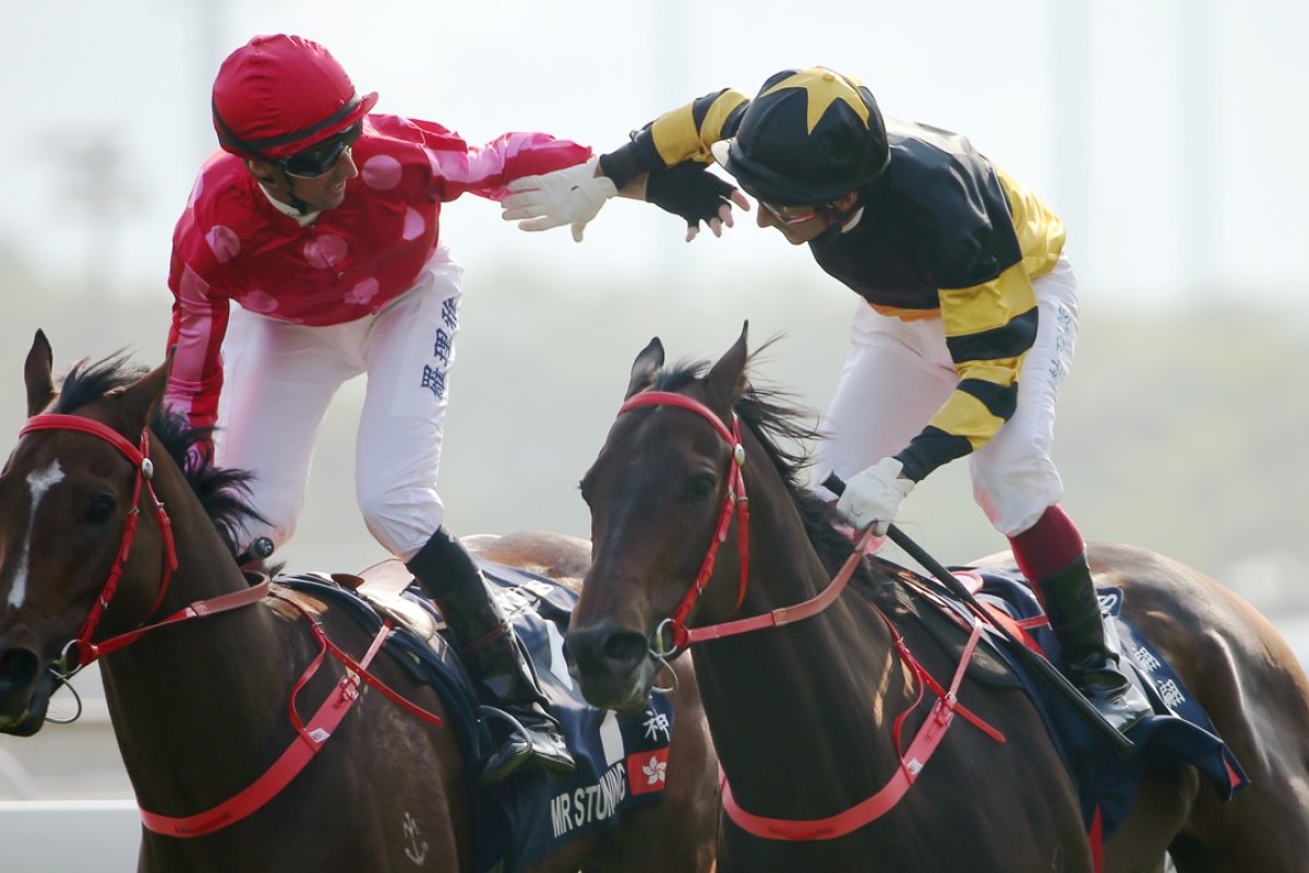 Nash Rawiller (left) and Olivier Doleuze lock arms at the finish of the Hong Kong Sprint. Photos: Kenneth Chan