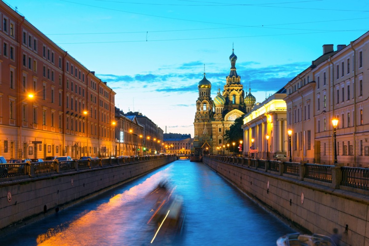 Tourist boats sail to the Church of Savior on Spilled Blood at White Night in St Petersburg, Russia. This is an architectural landmark of central St Petersburg, and a unique monument to Alexander II. Photo: Shutterstock