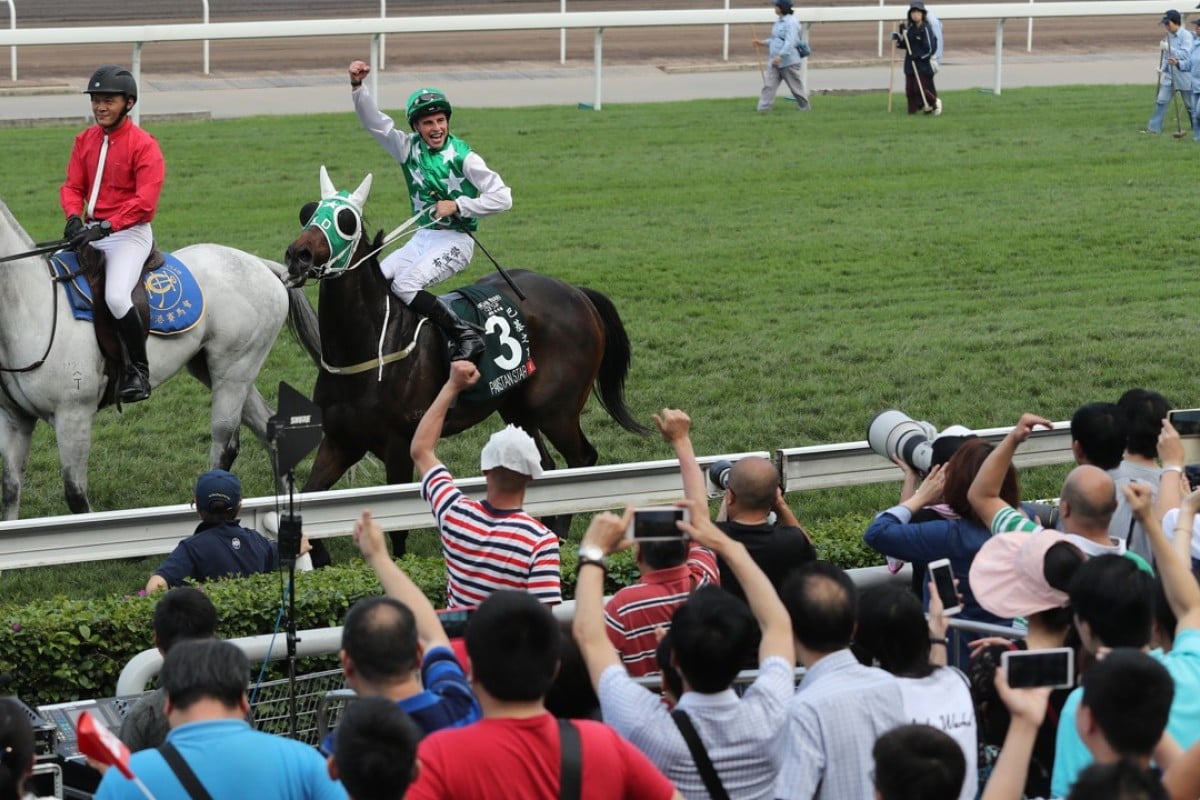 William Buick celebrates Pakistan Star’s QE II Cup win with the fans. Photos: Kenneth Chan